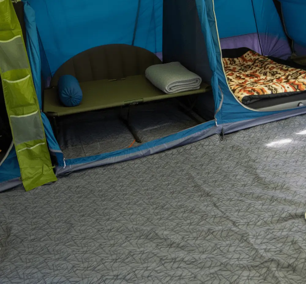 A soft tent carpet laid out inside a family tent.